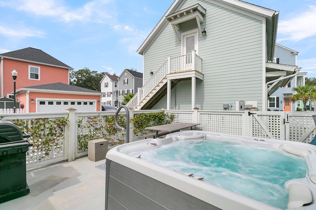 view of patio with grilling area and a hot tub