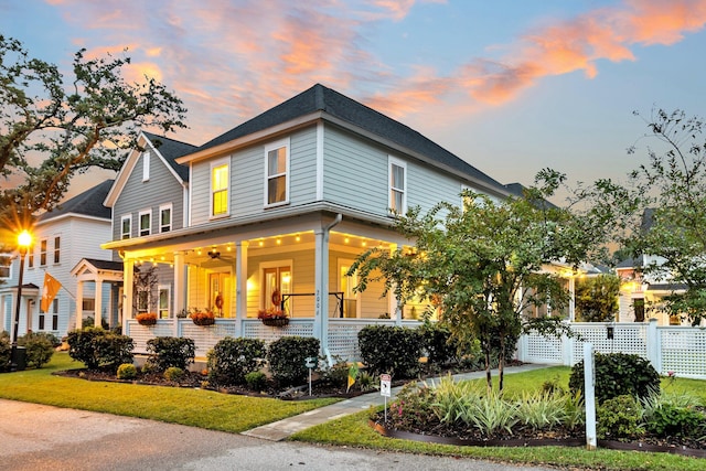 view of front of property featuring a lawn and a porch