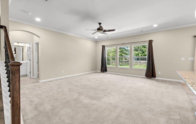 carpeted spare room with crown molding and ceiling fan