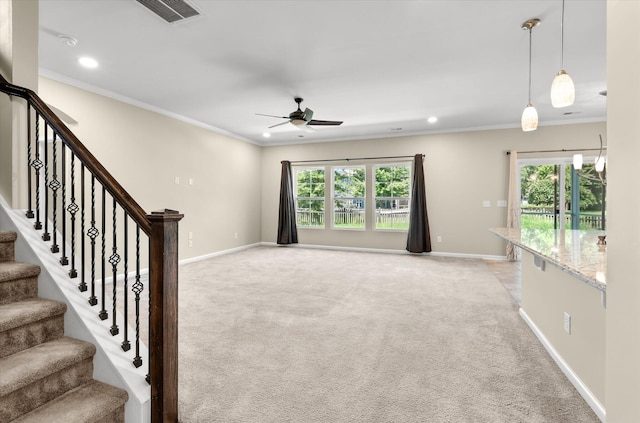 unfurnished living room featuring crown molding, light carpet, and ceiling fan