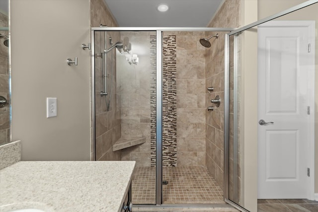 bathroom featuring vanity and a shower with shower door