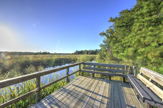 wooden deck featuring a water view