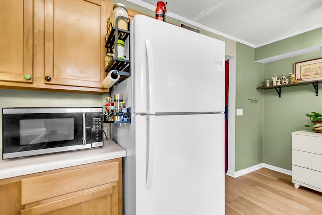 21 Rivers Point Row Apt 11C, Charleston, SC 29412 - kitchen with freestanding refrigerator, stainless steel microwave, light wood-style floors, baseboards, and light countertops