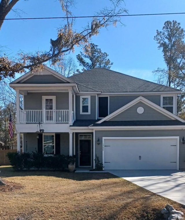 view of front of house featuring a garage and a front lawn