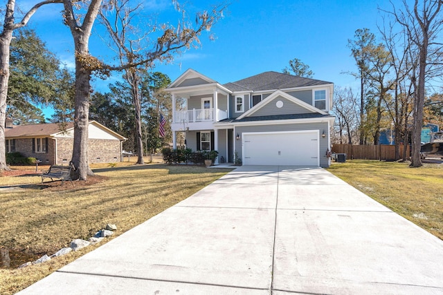 view of front of property with a balcony, a garage, central AC, and a front yard