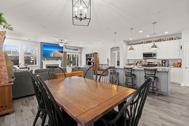 dining space featuring ceiling fan, a healthy amount of sunlight, and light hardwood / wood-style flooring