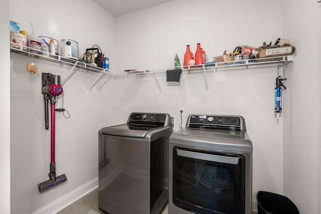 laundry room with washing machine and dryer and light tile patterned floors