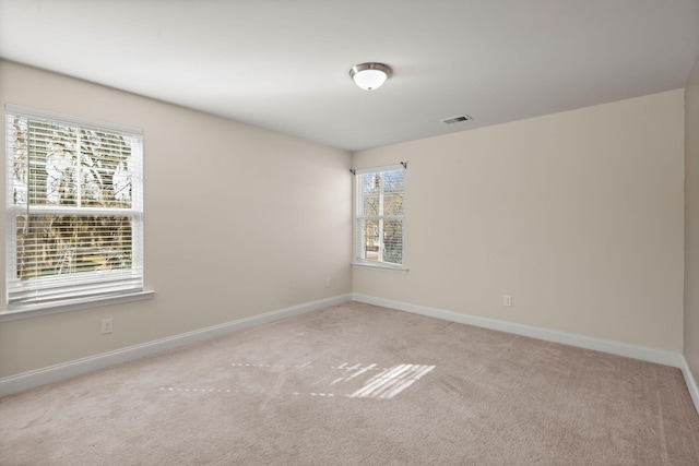 spare room with light carpet