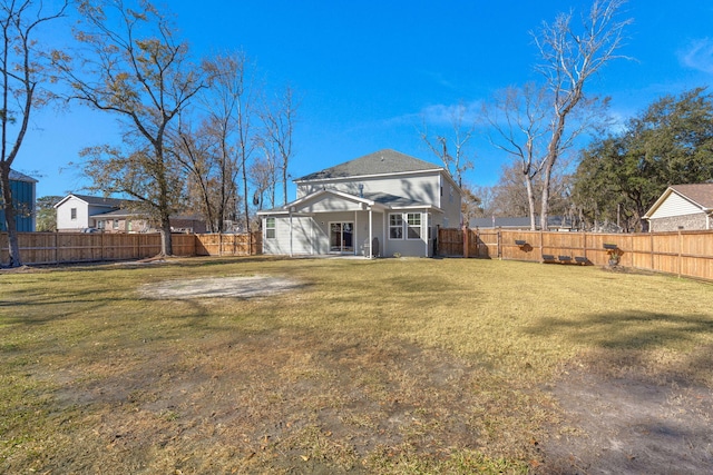 rear view of house featuring a yard