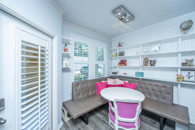 dining space featuring crown molding and wood finished floors