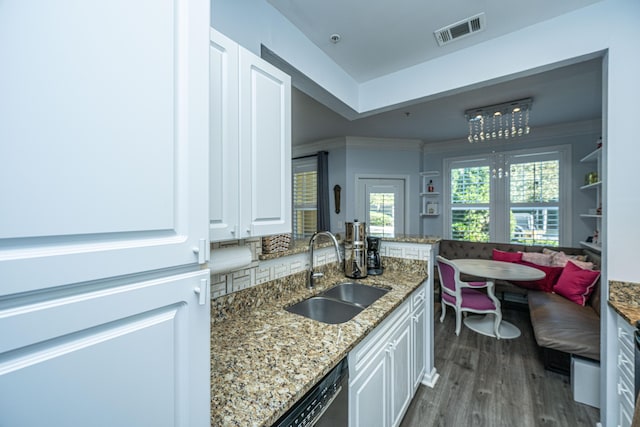 kitchen featuring dark wood-style flooring, white cabinetry, a sink, and visible vents