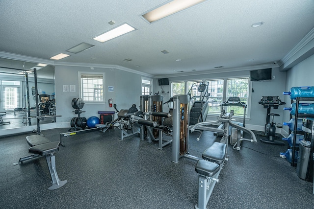 gym with a textured ceiling, baseboards, and crown molding