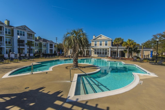 community pool featuring a patio and fence