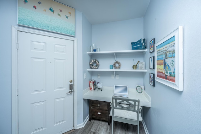 home office featuring dark wood-type flooring and baseboards