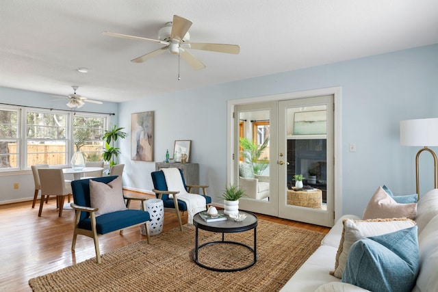 living room featuring wood finished floors, french doors, and ceiling fan