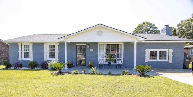 ranch-style house featuring a porch and a front yard