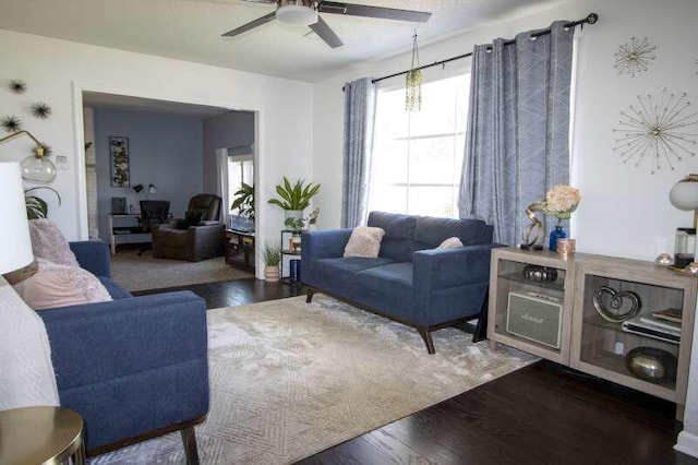 living room with ceiling fan and dark hardwood / wood-style flooring