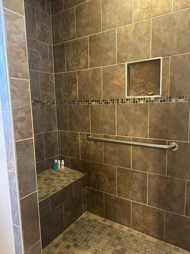 bathroom with a tile shower
