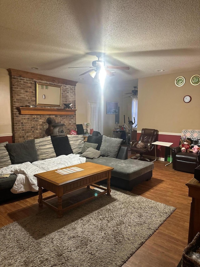 living room with wood-type flooring and a textured ceiling