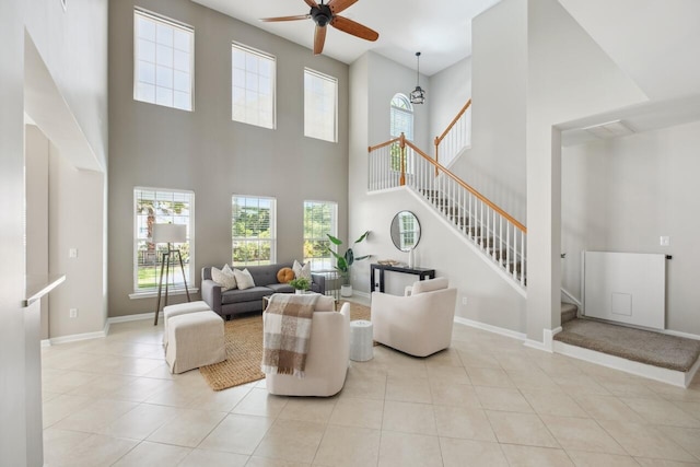 7511 Hawks Cir, Hanahan, SC 29410 - living room with ceiling fan, stairs, a towering ceiling, tile patterned floors, and healthy amount of natural light