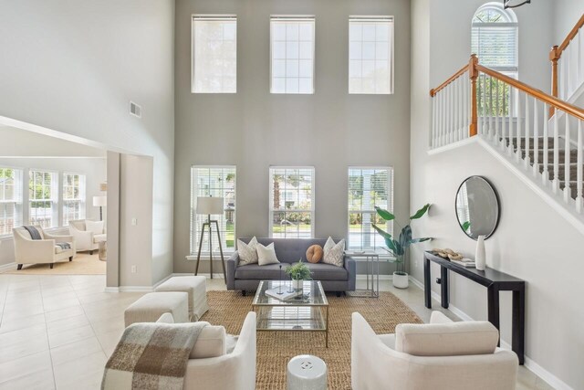 7511 Hawks Cir, Hanahan, SC 29410 - living room featuring a high ceiling, stairs, and tile patterned flooring
