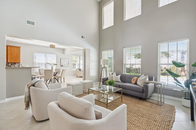 7511 Hawks Cir, Hanahan, SC 29410 - living room featuring light tile patterned floors and a towering ceiling