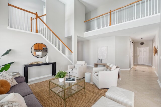 7511 Hawks Cir, Hanahan, SC 29410 - tiled living area featuring a towering ceiling and stairs