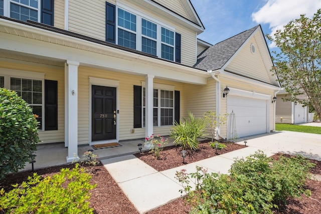 7511 Hawks Cir, Hanahan, SC 29410 - property entrance with a porch, driveway, and roof with shingles