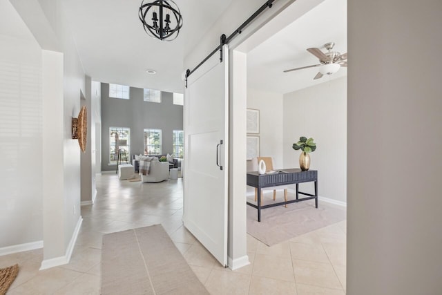 7511 Hawks Cir, Hanahan, SC 29410 - hall featuring a barn door, light tile patterned flooring, and a chandelier