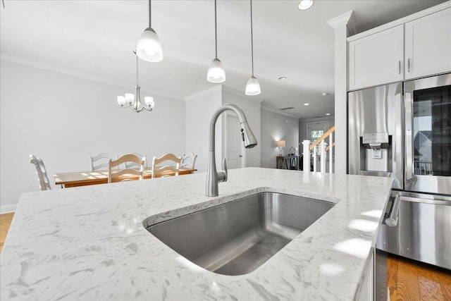 kitchen with crown molding, a sink, stainless steel fridge with ice dispenser, and wood finished floors