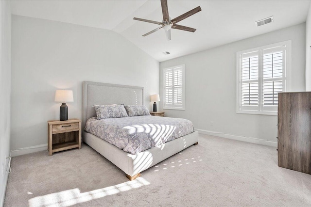 carpeted bedroom featuring lofted ceiling, visible vents, and baseboards