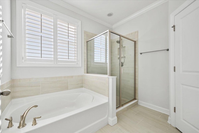 bathroom with a shower stall, crown molding, baseboards, and a bath