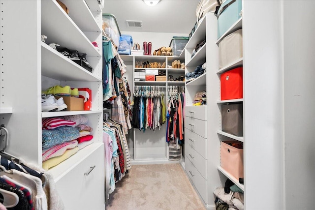 spacious closet with visible vents and light colored carpet