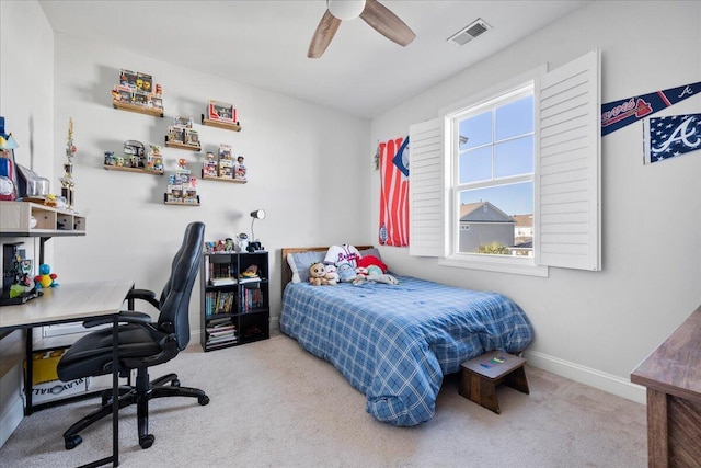 carpeted bedroom featuring ceiling fan, visible vents, and baseboards