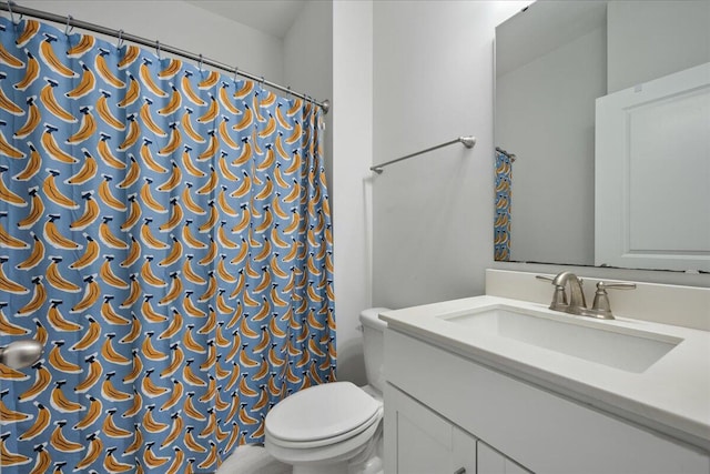 bathroom with toilet, curtained shower, and vanity