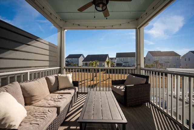 wooden terrace featuring a residential view, outdoor lounge area, and a ceiling fan