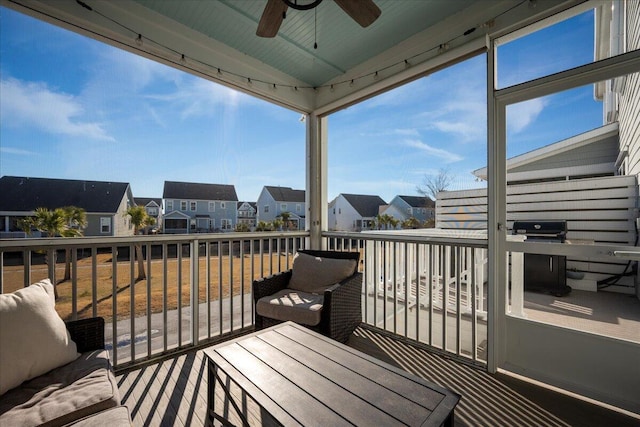 wooden terrace featuring grilling area, a residential view, and a ceiling fan