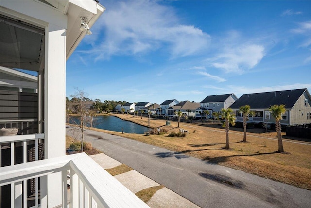 balcony featuring a water view and a residential view