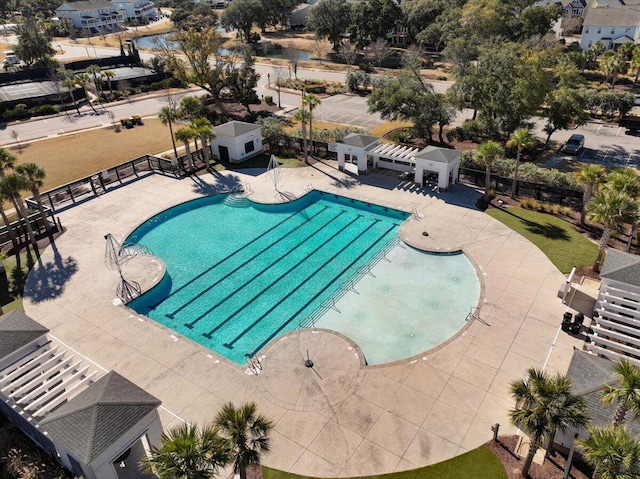 community pool with a patio, fence, and a pergola