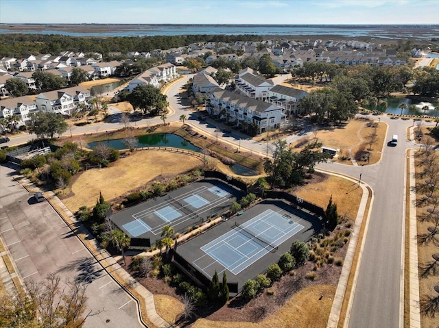 drone / aerial view with a water view and a residential view