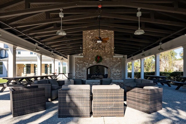 view of patio / terrace with an outdoor living space with a fireplace