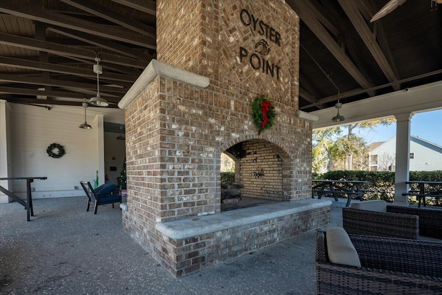 view of patio / terrace featuring an outdoor brick fireplace