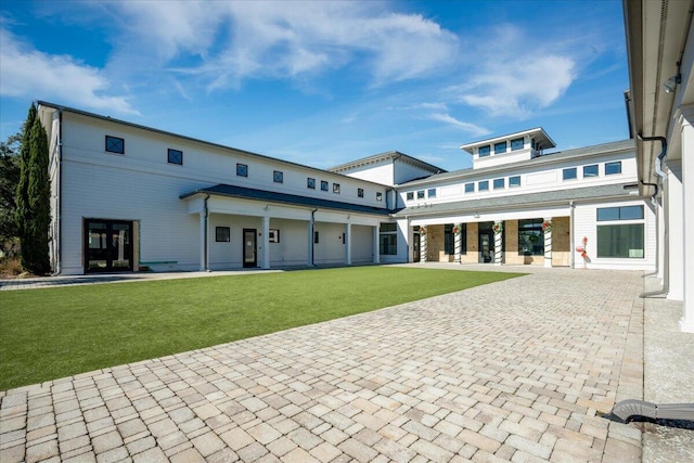 rear view of house with a yard