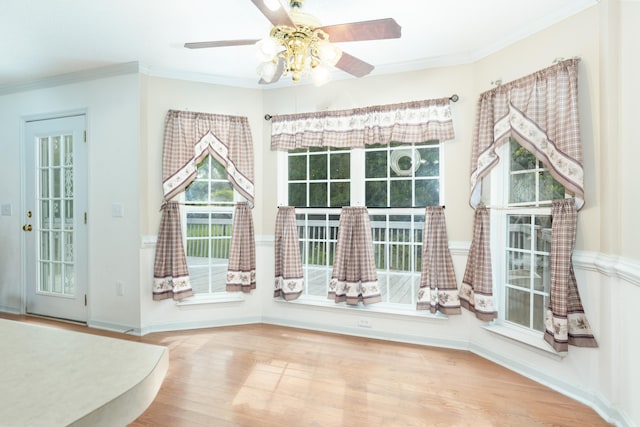 interior space featuring ceiling fan, ornamental molding, and hardwood / wood-style flooring