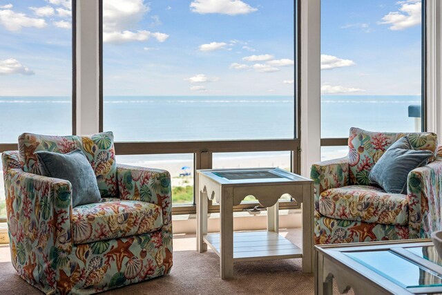 interior space with carpet flooring and a water view