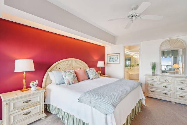 carpeted bedroom featuring ceiling fan and ensuite bathroom