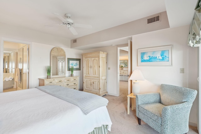 carpeted bedroom featuring ceiling fan and ensuite bath