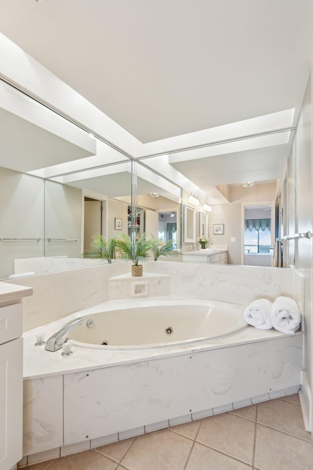 bathroom featuring a bathtub, tile patterned flooring, and vanity