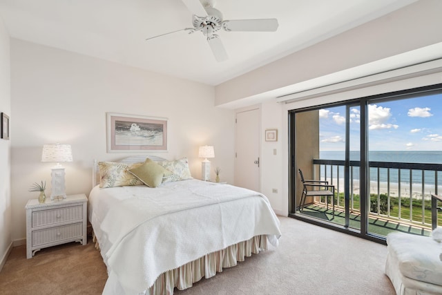 carpeted bedroom featuring ceiling fan, access to outside, and a water view