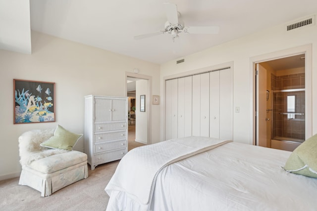 carpeted bedroom featuring ceiling fan, connected bathroom, and a closet